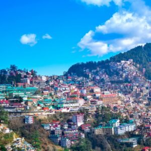 city near mountain under blue sky during daytime